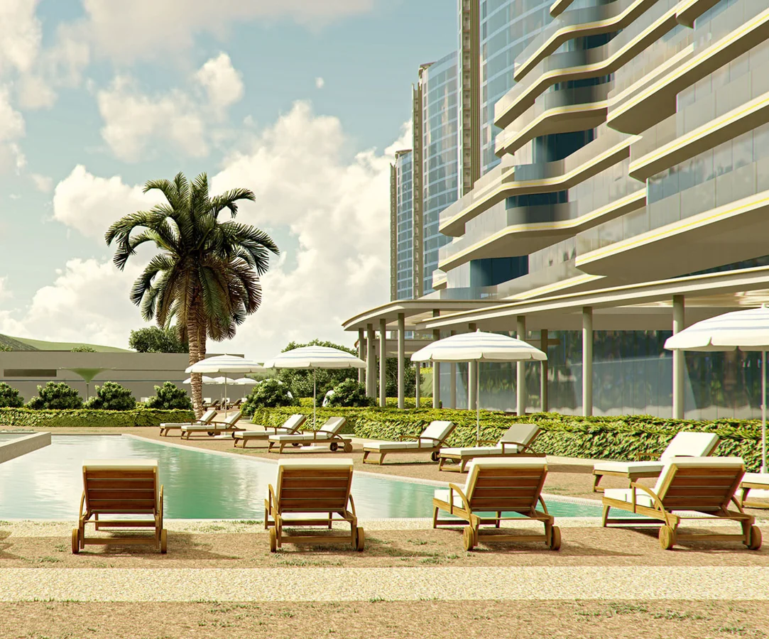 Pool deck with sun loungers below the residences